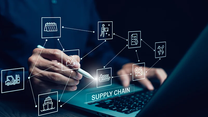 Supply chain icons connected in a network diagram over a laptop