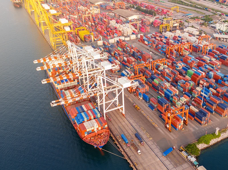 Aerial view of a container port with cranes and cargo ships