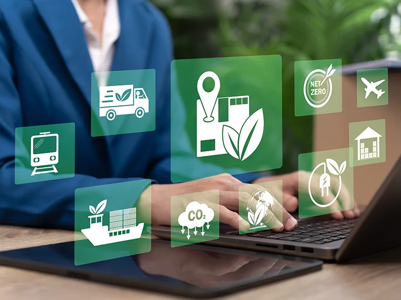 Green logistics icons floating above a laptop representing sustainable supply chain research